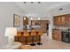 Kitchen with island bar seating and gorgeous cabinetry, complete with stainless steel appliances at 6128 E Brilliant Sky Dr, Scottsdale, AZ 85266