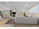 Bright living room with a fireplace, large sofa, and white interior features at 6128 E Brilliant Sky Dr, Scottsdale, AZ 85266