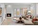 Cozy living area featuring a fireplace, comfortable seating, and access to outdoor spaces at 6128 E Brilliant Sky Dr, Scottsdale, AZ 85266