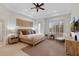 Relaxing main bedroom features neutral colors, a ceiling fan, and a large window with shutters at 6128 E Brilliant Sky Dr, Scottsdale, AZ 85266