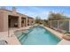Inviting pool area featuring a pristine pool, desert landscaping, and an attached covered patio with comfortable seating at 6128 E Brilliant Sky Dr, Scottsdale, AZ 85266