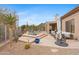 Relaxing backyard pool area featuring a baja deck, desert landscaping, and comfortable seating at 6128 E Brilliant Sky Dr, Scottsdale, AZ 85266