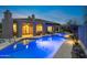 Backyard view of the pool and spa with a covered patio, lounge furniture, and desert landscaping at 6128 E Brilliant Sky Dr, Scottsdale, AZ 85266