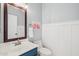 Charming half-bath with updated fixtures, wainscotting, and framed mirror at 6230 S Mesa Vista Dr, Gold Canyon, AZ 85118