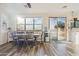 Sun-drenched dining room with a large window, sliding glass door and wood-look floors at 6230 S Mesa Vista Dr, Gold Canyon, AZ 85118