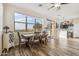 Bright dining area with a large window view, a modern chandelier, and an adjacent modern kitchen at 6230 S Mesa Vista Dr, Gold Canyon, AZ 85118