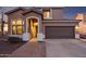 Charming two-story home with a tiled roof, arched entryway, and attached two-car garage at 6230 S Mesa Vista Dr, Gold Canyon, AZ 85118