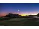 Nighttime view of the golf course with mountains, illuminated by the moon and stars, creating a magical ambiance at 6230 S Mesa Vista Dr, Gold Canyon, AZ 85118