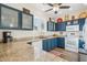 Bright kitchen boasts custom blue cabinets, granite countertops, stainless appliances and wood-look floors at 6230 S Mesa Vista Dr, Gold Canyon, AZ 85118