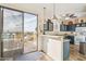 Modern kitchen featuring granite countertops, stainless steel appliances, and a walk-out to a patio at 6230 S Mesa Vista Dr, Gold Canyon, AZ 85118