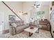 Bright living room featuring high ceilings, a ceiling fan, and comfortable seating on top of a large area rug at 6230 S Mesa Vista Dr, Gold Canyon, AZ 85118