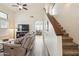 Spacious living room with high ceilings, a ceiling fan, wood flooring, and staircase with carpet at 6230 S Mesa Vista Dr, Gold Canyon, AZ 85118
