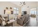 Open-concept living room featuring a high ceiling, comfortable seating, and a large window with shutters at 6230 S Mesa Vista Dr, Gold Canyon, AZ 85118