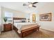Comfortable bedroom with a ceiling fan, natural light, and an en-suite bathroom at 6230 S Mesa Vista Dr, Gold Canyon, AZ 85118