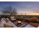 Relaxing patio area with a fire pit, comfortable seating, and panoramic views of the surrounding landscape at 6230 S Mesa Vista Dr, Gold Canyon, AZ 85118