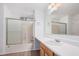 Bathroom featuring a shower-tub combination with glass doors and a single sink vanity at 663 E Los Arboles Pl, Chandler, AZ 85225