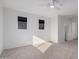 A bright bedroom featuring neutral carpet and two windows for ample natural light at 663 E Los Arboles Pl, Chandler, AZ 85225