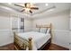 Comfortable bedroom features hardwood floors, a cozy brass bed, and bright shutters at 6803 E Main St # 2210, Scottsdale, AZ 85251