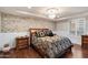 This luxurious bedroom boasts hardwood floors, decorative brickwork, and a crystal chandelier at 6803 E Main St # 2210, Scottsdale, AZ 85251