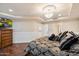 A bedroom with hardwood floors, white wainscoting, and a ceiling fan at 6803 E Main St # 2210, Scottsdale, AZ 85251