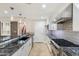 A gourmet kitchen features white cabinets, granite countertops, and stainless steel appliances at 6803 E Main St # 2210, Scottsdale, AZ 85251