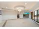 Spacious living room with tile flooring, open to outdoor patio, and elegant chandelier at 6803 E Main St # 2210, Scottsdale, AZ 85251