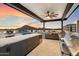 Luxury rooftop kitchen with modern appliances and bar seating against scenic views and a colorful sky at 6803 E Main St # 2210, Scottsdale, AZ 85251