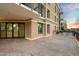 Wide patio area with outdoor lighting showcasing a building with scenic sky background at 6803 E Main St # 2210, Scottsdale, AZ 85251