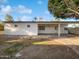 Large backyard with a covered patio, offering ample space for outdoor living and entertaining at 701 W Wilshire Dr, Phoenix, AZ 85007