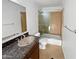 Bathroom with a granite countertop sink and a glass-enclosed shower at 701 W Wilshire Dr, Phoenix, AZ 85007