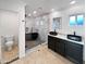 Modern bathroom features dual vessel sinks, a marble-lined walk-in shower, and a separate toilet room at 701 W Wilshire Dr, Phoenix, AZ 85007