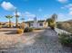 Charming single-story home with a blue door and white exterior, complemented by desert landscaping and palm trees at 701 W Wilshire Dr, Phoenix, AZ 85007