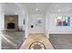 Inviting foyer with decorative tile flooring that leads into a spacious living area with a stone fireplace at 701 W Wilshire Dr, Phoenix, AZ 85007