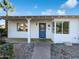Welcoming front entrance with a blue door, desert landscaping, and covered porch with great curb appeal at 701 W Wilshire Dr, Phoenix, AZ 85007