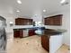 Well-equipped kitchen with stainless steel appliances, dark wood cabinetry, and a breakfast bar at 701 W Wilshire Dr, Phoenix, AZ 85007