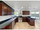 Well-equipped kitchen features stainless steel appliances, dark wood cabinets, and black countertops with a view at 701 W Wilshire Dr, Phoenix, AZ 85007