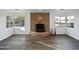 Bright living room featuring a stone fireplace, and bay windows with a street view at 701 W Wilshire Dr, Phoenix, AZ 85007