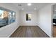 Well-lit living room with wood floors, white trim, and large window offering a bright and open space at 701 W Wilshire Dr, Phoenix, AZ 85007