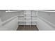 Organized walk-in closet with white shelving and racks, providing ample storage space at 701 W Wilshire Dr, Phoenix, AZ 85007