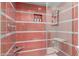 Shower stall featuring modern red and grey tiling, a rainfall shower head and built in niche for toiletries at 7720 E Heatherbrae Ave # 13, Scottsdale, AZ 85251