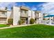 Condo featuring a lush green lawn and a community pool in the background at 7720 E Heatherbrae Ave # 13, Scottsdale, AZ 85251