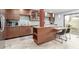 Spacious kitchen featuring tiled floors, wood cabinets, tile backsplash, and a center island with seating at 7720 E Heatherbrae Ave # 13, Scottsdale, AZ 85251