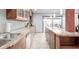 Bright kitchen with stainless steel sink, island, and sliding glass doors to the outdoor patio at 7720 E Heatherbrae Ave # 13, Scottsdale, AZ 85251