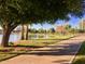 Picturesque park featuring a serene lake, walking path, lush grass, and mature trees offering plenty of shade at 7720 E Heatherbrae Ave # 13, Scottsdale, AZ 85251