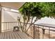 Outdoor patio featuring mature trees, a metal railing and white brick walls at 7720 E Heatherbrae Ave # 13, Scottsdale, AZ 85251