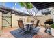 Cozy patio featuring a dining set on a patterned rug with hanging string lights and grill at 7720 E Heatherbrae Ave # 13, Scottsdale, AZ 85251