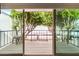 Spacious outdoor patio with lush green trees and a metal railing at 7720 E Heatherbrae Ave # 13, Scottsdale, AZ 85251