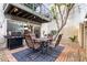 Inviting backyard patio featuring a dining set, grill, and lush green plants at 7720 E Heatherbrae Ave # 13, Scottsdale, AZ 85251