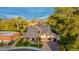 Expansive aerial view of a beautifully maintained property showcasing its lush landscaping, mature trees, and tile roof at 7721 N Via De La Montana --, Scottsdale, AZ 85258