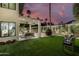 Charming backyard featuring a covered patio, sparkling pool, lush lawn, and mature landscaping at 7721 N Via De La Montana --, Scottsdale, AZ 85258